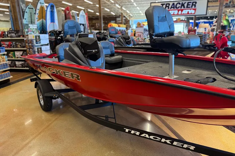 Slide: The Image of Red 2026 Tracker Pro Team 175 Crappie Edition boat displayed in a showroom. - 8