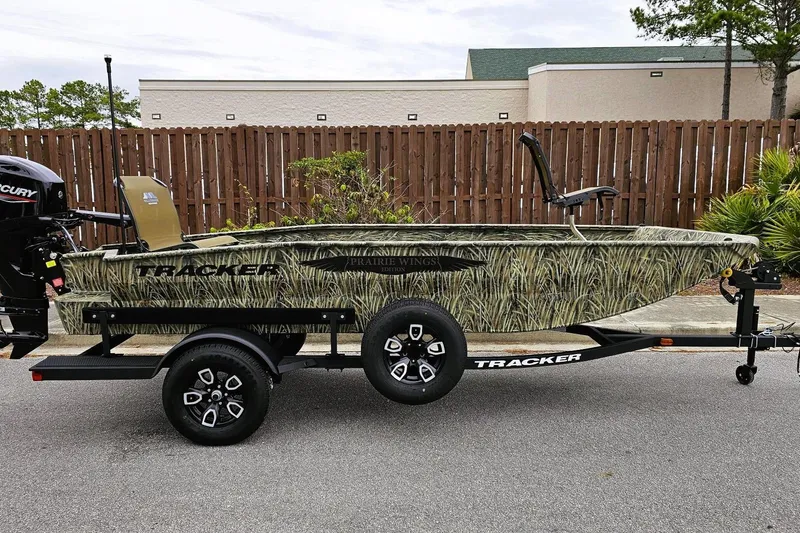 Slide: The Image of 2026 Tracker Grizzly 1650 T Prairie Wings Edition boat on trailer, camo design. - 10