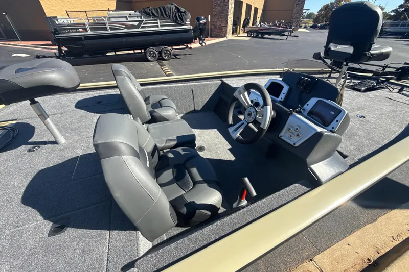 Slide: The Image of 2026 Tracker Pro Team 195 boat interior with steering wheel and seating. - 5