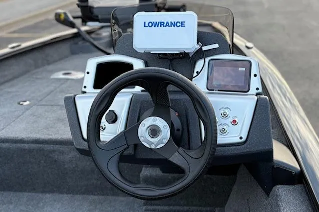 Slide: The Image of 2026 Tracker Pro Team 175 Crappie Edition boat with Mercury 75 engine, parked near a river. - 10