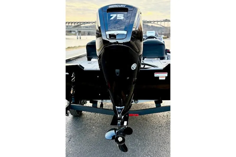 Slide: The Image of 2026 Tracker Pro Team 175 Crappie Edition boat on trailer by a lake. - 20