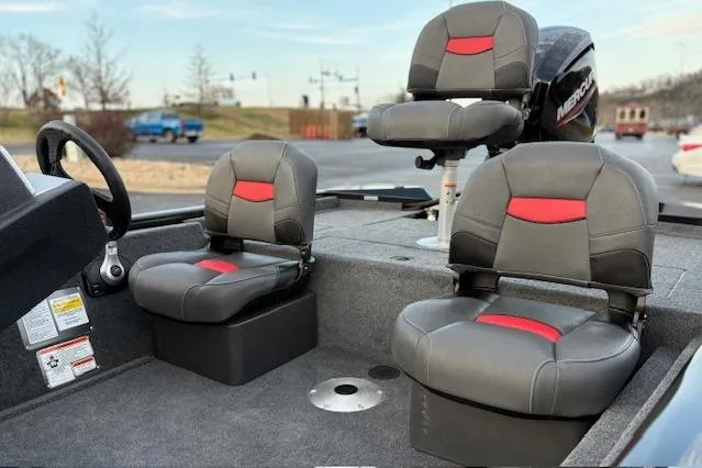 Slide: The Image of 2026 Tracker Pro Team 175 Crappie Edition boat interior with fishing rod holders and seating. - 6