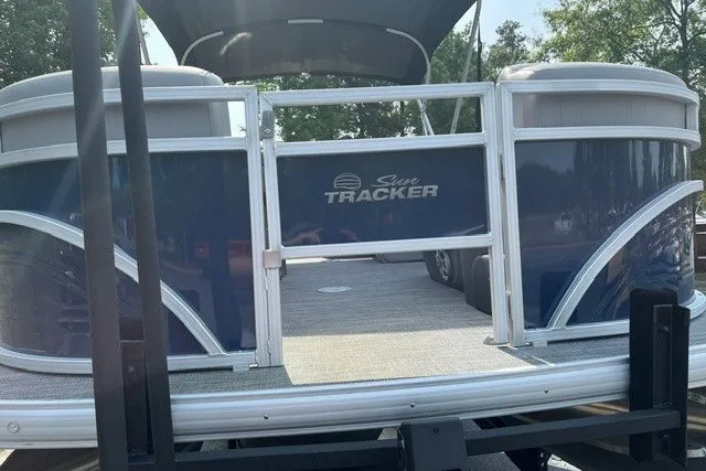Slide: The Image of 2026 Sun Tracker SportFish 22 DLX pontoon boat, rear view, on trailer. - 14