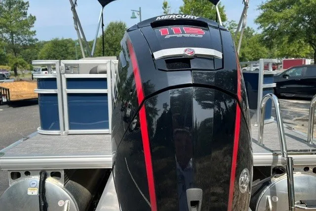 Slide: The Image of 2026 Sun Tracker SportFish 22 DLX with Mercury 115 outboard motor, parked outdoors. - 15