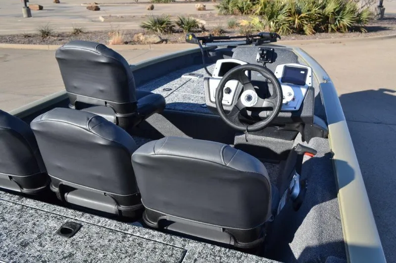 Slide: The Image of 2026 Tracker Pro Team 175 Crappie Edition boat interior with steering wheel and seats. - 5