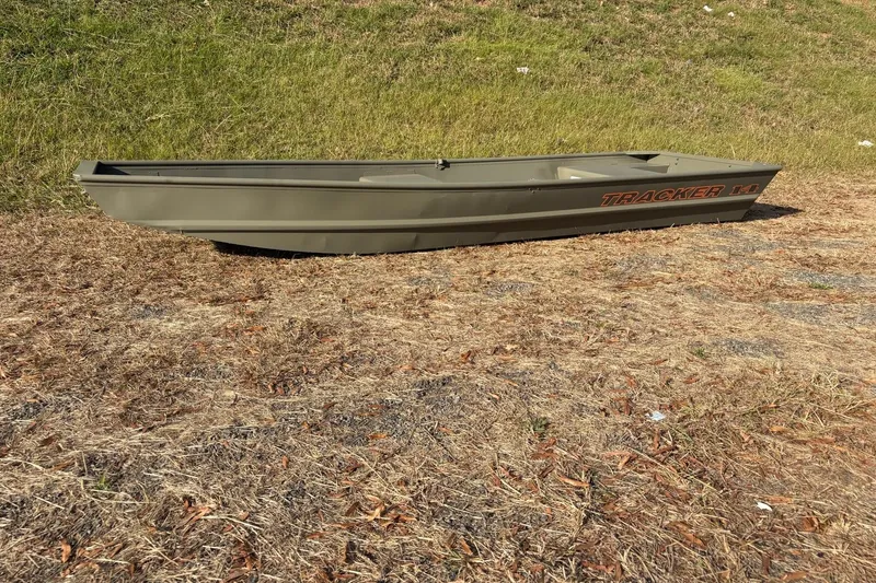 The Image of 2026 Tracker Grizzly 14 Jon boat on dry grass, side view. - 0