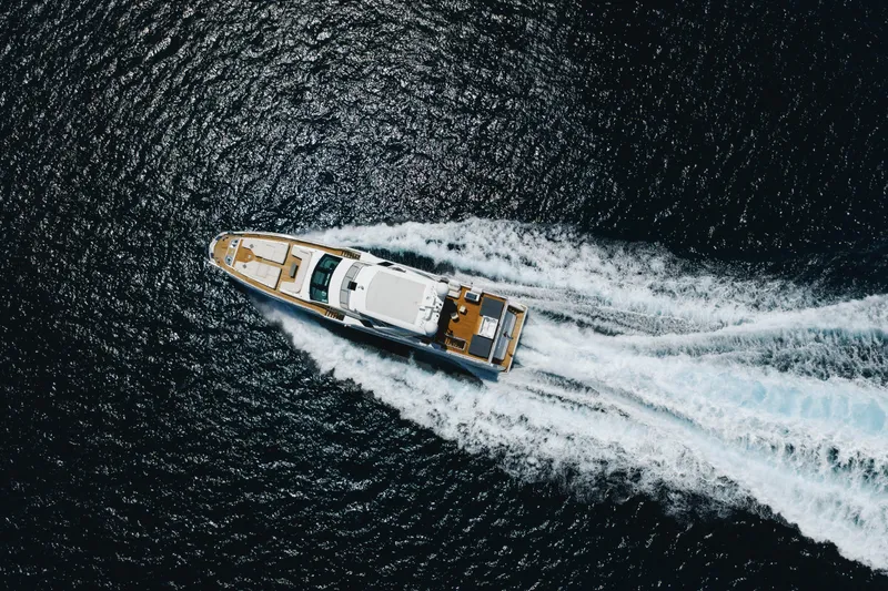 Slide: The Image of Aerial view of 2023 Azimut yacht cruising on open water, leaving a white wake. - 11