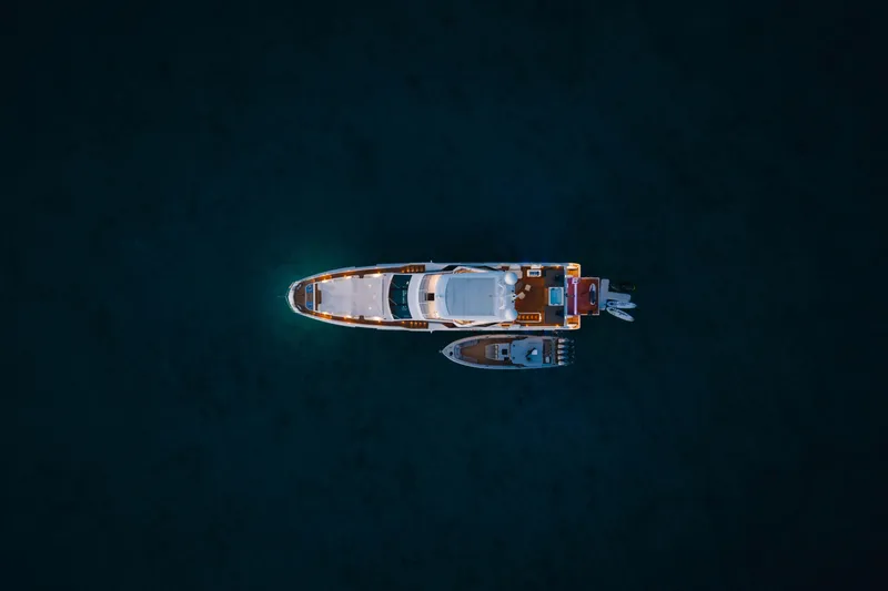 Slide: The Image of Aerial view of 2023 Azimut yacht on dark water, illuminated at night. - 22