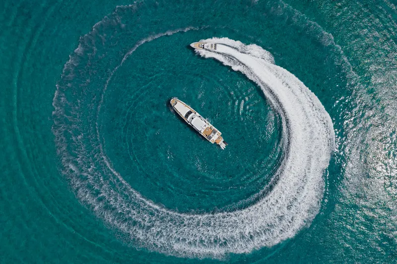 Slide: The Image of Aerial view of 2023 Azimut yacht creating circular wake in turquoise water. - 3