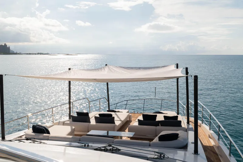 Slide: The Image of Luxurious 2023 Azimut yacht deck with shaded seating, overlooking serene ocean waters. - 33