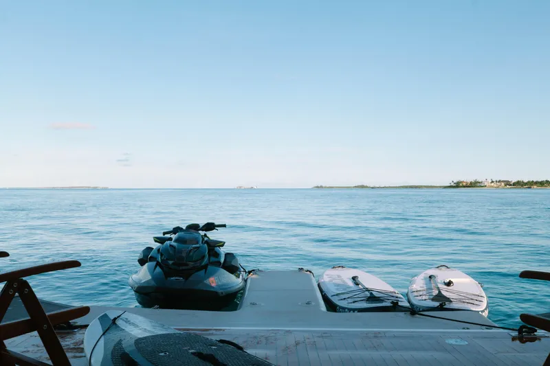 Slide: The Image of Jet ski and paddleboards on Azimut yacht, 2023, with serene ocean view. - 35