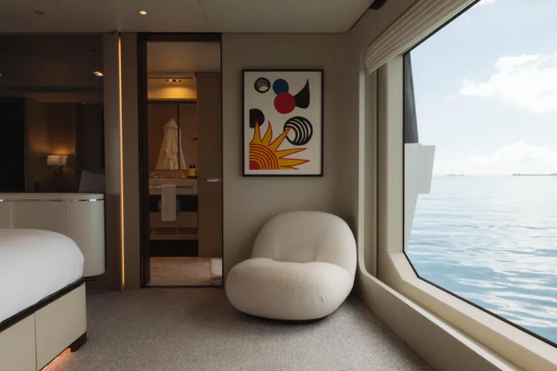 Slide: The Image of Luxurious Azimut yacht interior with modern art, plush chair, and ocean view, 2023 model. - 39