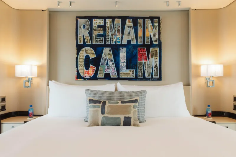 Slide: The Image of Luxurious bedroom on 2023 Azimut 32M Grande yacht with "Remain Calm" artwork. - 40