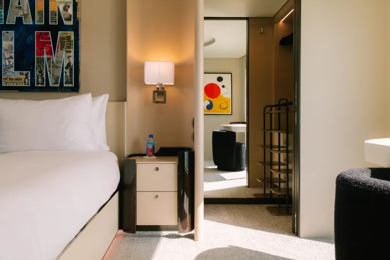 Slide: The Image of Modern hotel room with stylish decor, abstract art, and cozy lighting, featuring Azimut design elements. - 44