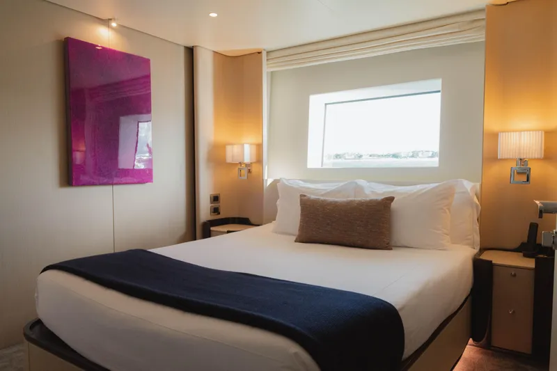 Slide: The Image of Luxurious Azimut yacht bedroom, 2023 model, featuring elegant decor and a large window view. - 47