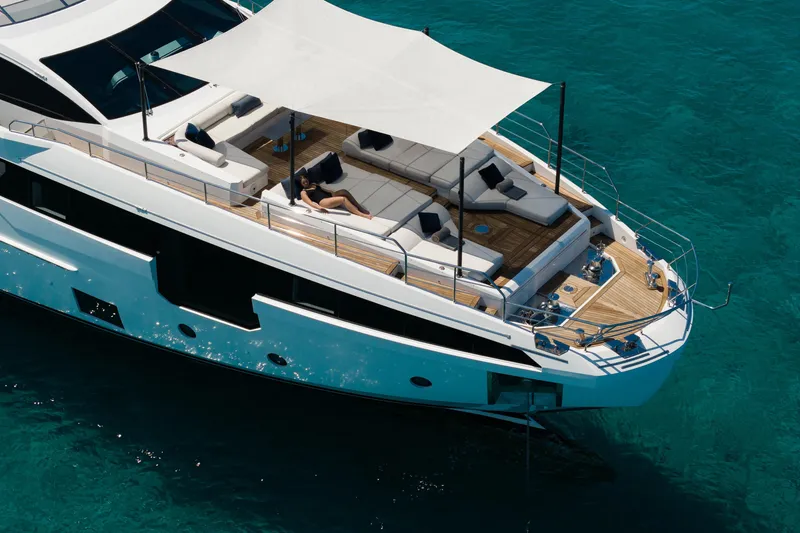Slide: The Image of Luxurious 2023 Azimut yacht with spacious deck and sunshade on clear blue water. - 5