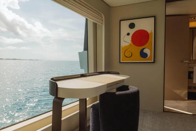 Slide: The Image of Luxurious Azimut yacht interior with ocean view, modern desk, and abstract art, 2023 model. - 51