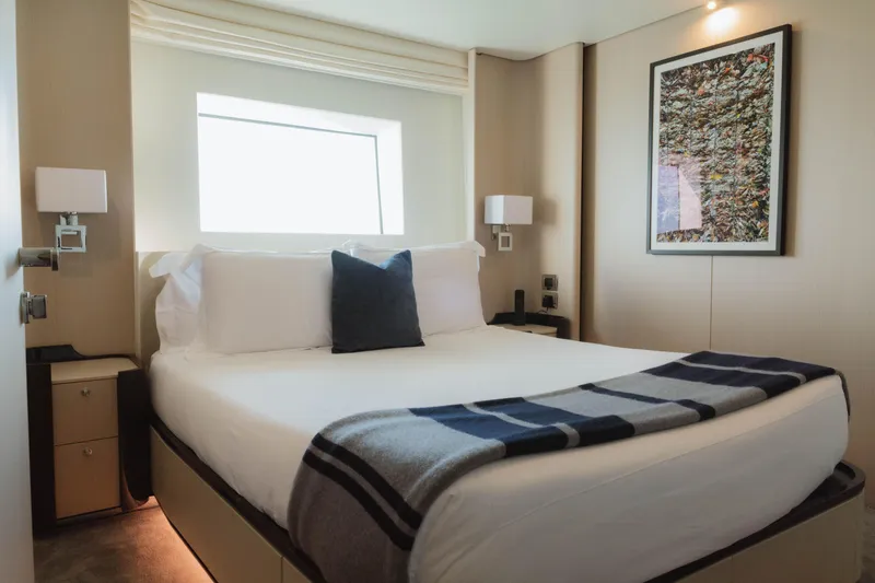 Slide: The Image of Luxurious 2023 Azimut yacht bedroom with modern decor and cozy bedding. - 60