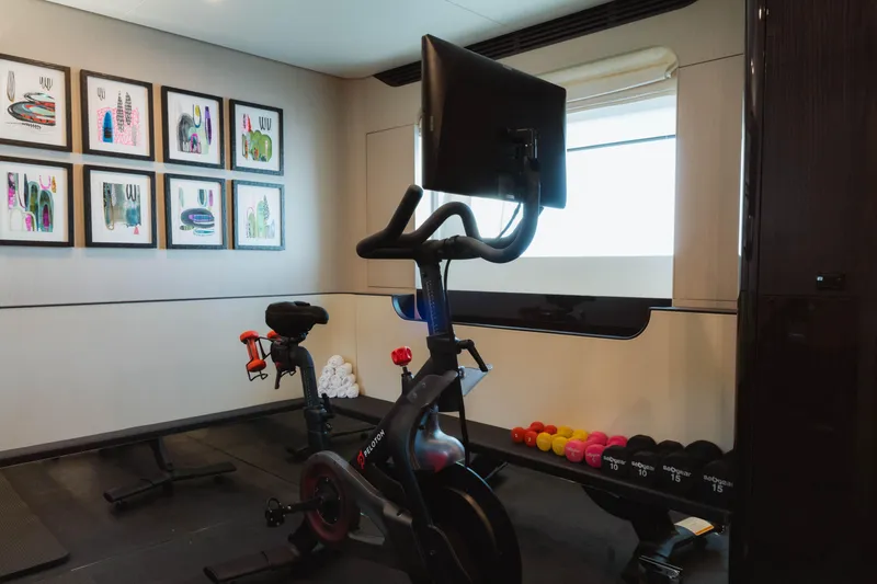 Slide: The Image of Home gym on 2023 Azimut 32M Grande yacht with Peloton bike and weights. - 61
