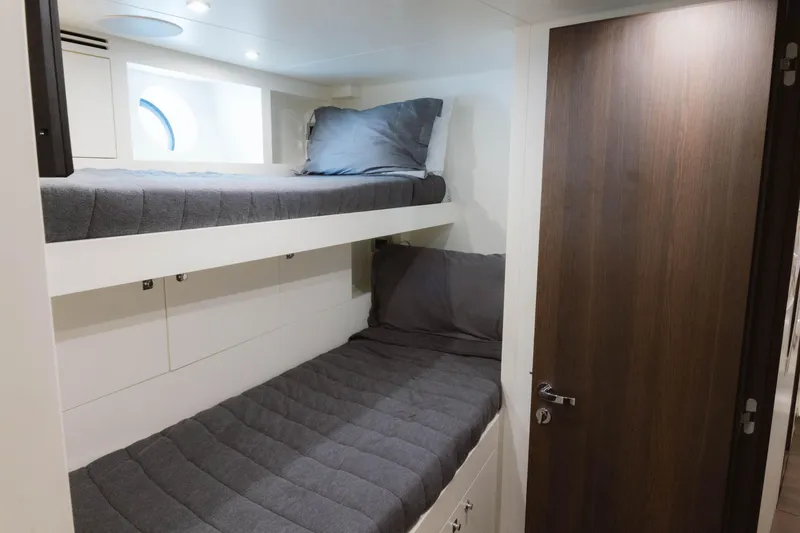 Slide: The Image of 2023 Azimut 32M Grande yacht cabin with bunk beds and modern design. - 73