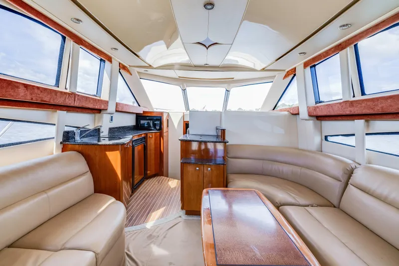 Slide: The Image of Luxurious interior of a 2006 Meridian 341 Sedan yacht with leather seating and wooden finishes. - 10