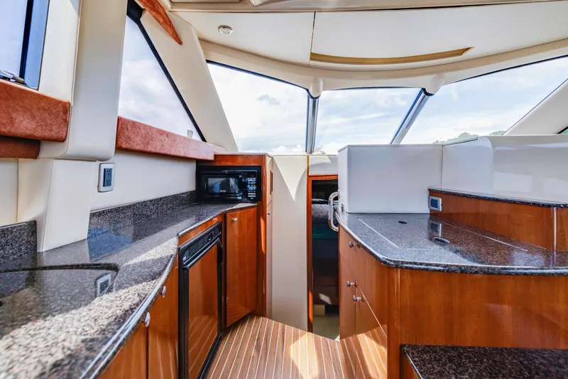 Slide: The Image of Luxurious interior of 2006 Meridian 341 Sedan yacht with modern kitchen amenities. - 13