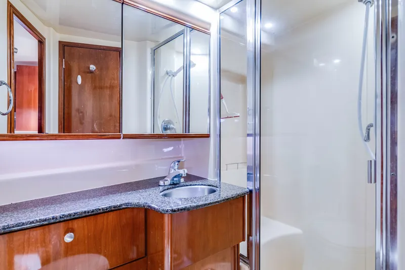 Slide: The Image of Luxurious bathroom in 2006 Meridian 341 Sedan yacht with modern fixtures and glass shower. - 22