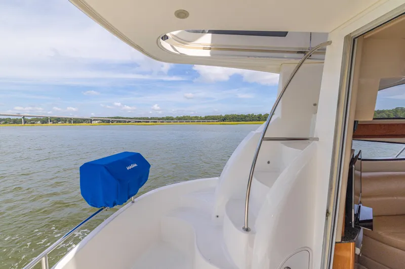 Slide: The Image of 2006 Meridian 341 Sedan yacht with scenic water view and blue cover. - 26