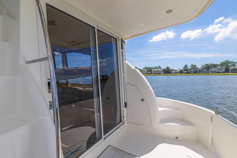 Slide: The Image of 2006 Meridian 341 Sedan yacht interior with water view, featuring sleek design and spacious seating. - 29