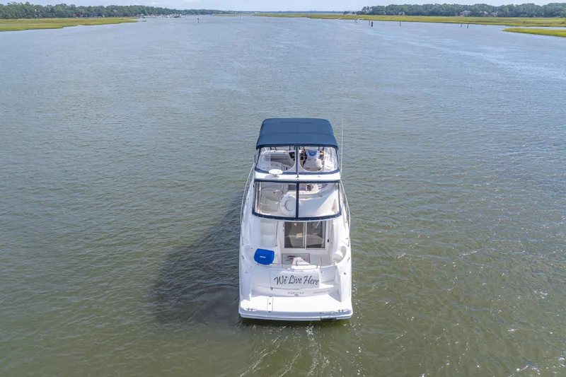 Slide: The Image of 2006 Meridian 341 Sedan cruising on a calm river under clear skies. - 3