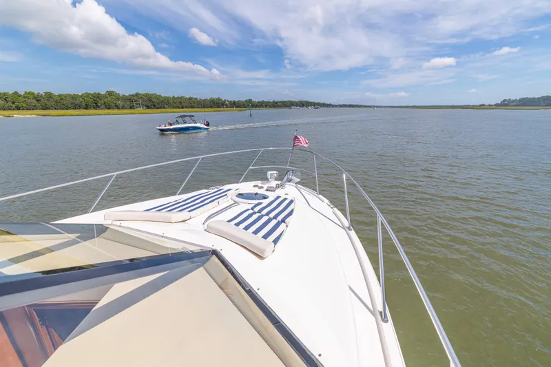 Slide: The Image of 2006 Meridian 341 Sedan cruising on a serene lake under a clear blue sky. - 32