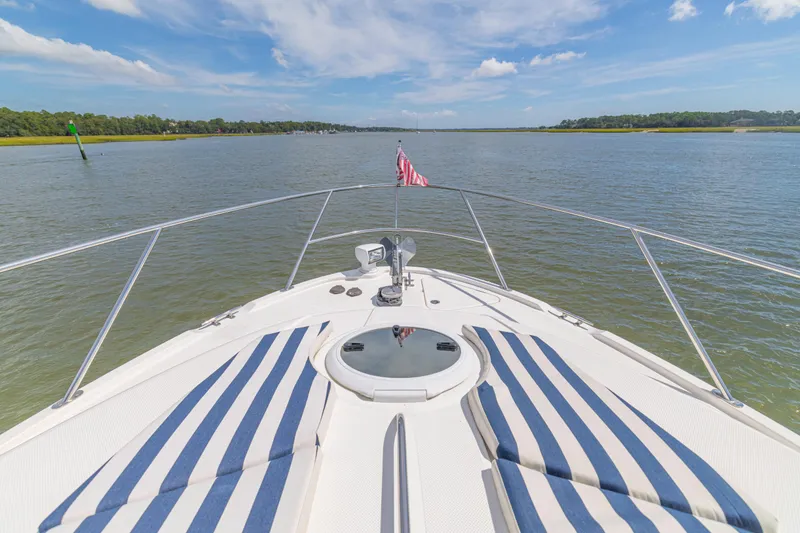 Slide: The Image of Bow view of 2006 Meridian 341 Sedan yacht on calm waters under blue sky. - 33