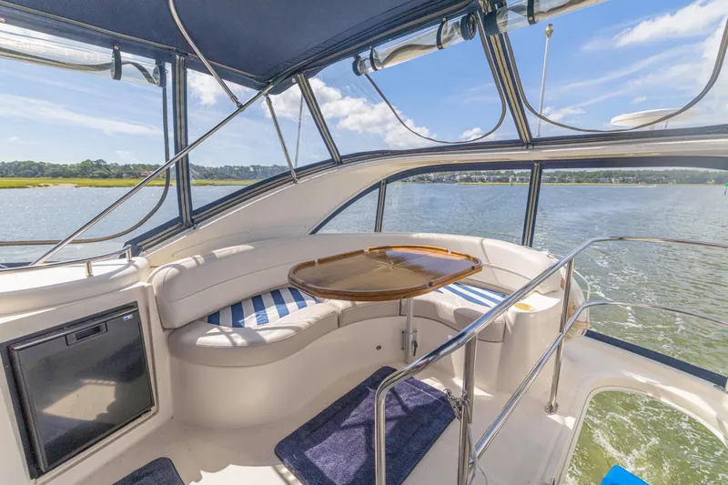 Slide: The Image of 2006 Meridian 341 Sedan yacht interior with seating, table, and scenic water view. - 38