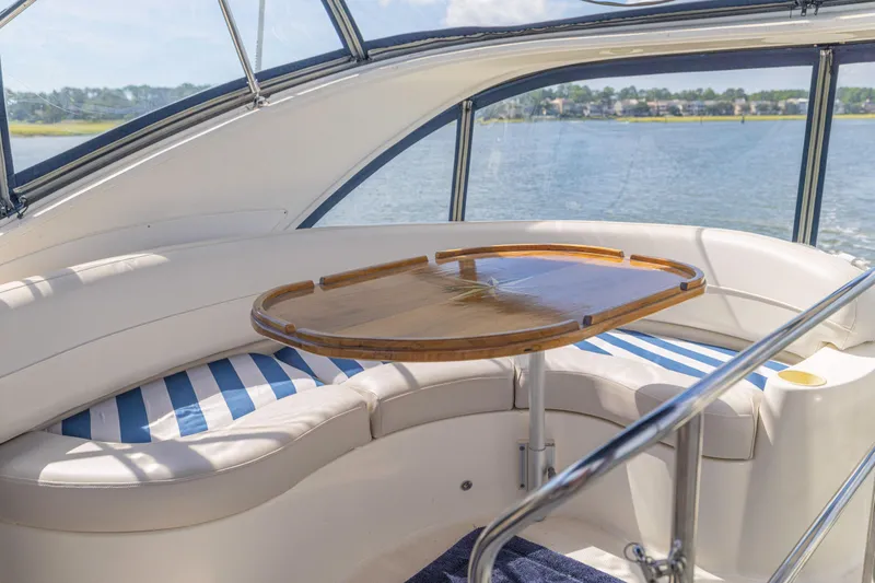 Slide: The Image of Luxurious seating area on a 2006 Meridian 341 Sedan yacht with scenic water view. - 39