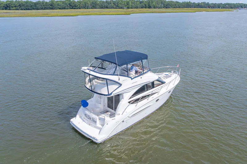 Slide: The Image of 2006 Meridian 341 Sedan cruising on a calm river with lush green shoreline. - 4