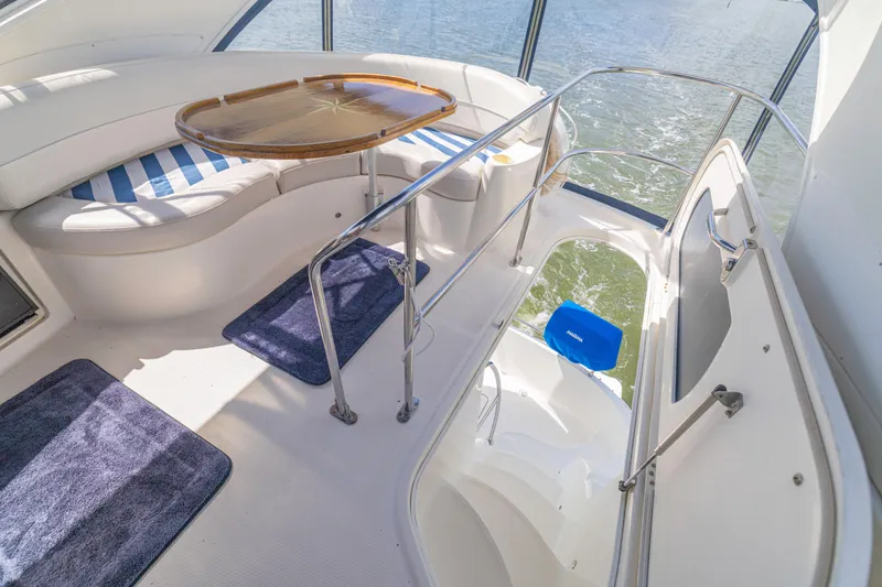 Slide: The Image of 2006 Meridian 341 Sedan yacht interior with seating, table, and water view. - 40