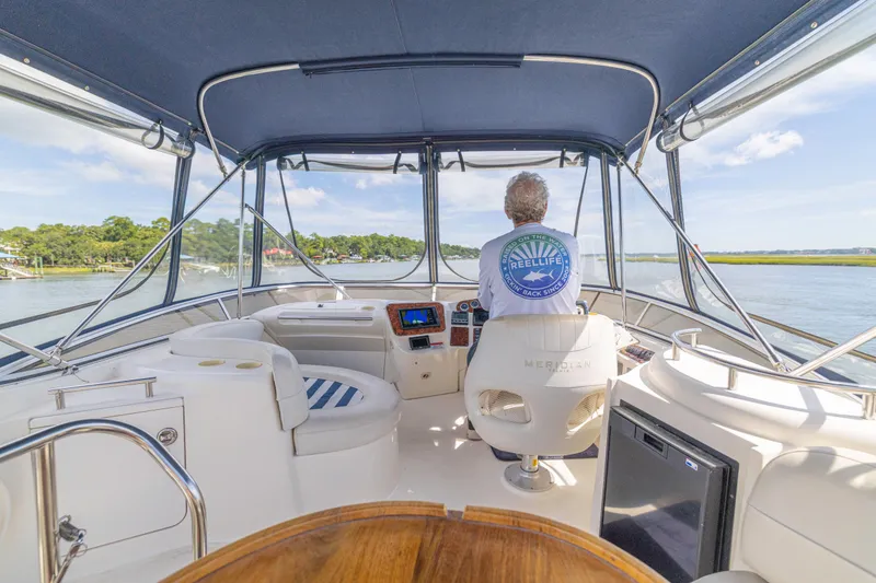 Slide: The Image of 2006 Meridian 341 Sedan interior with captain steering on a sunny day. - 43