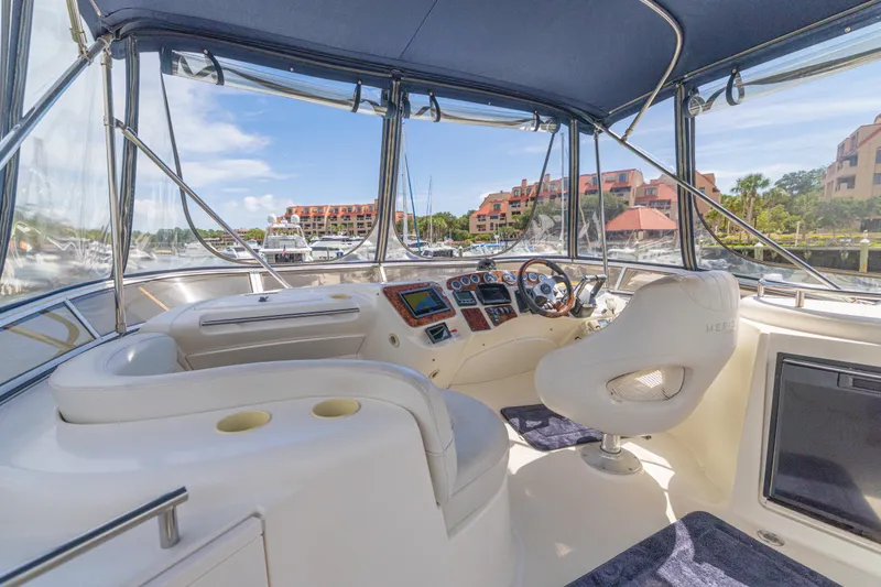 Slide: The Image of 2006 Meridian 341 Sedan yacht interior with helm, luxurious seating, and marina view. - 45