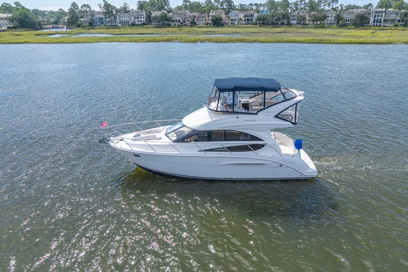 Slide: The Image of 2006 Meridian 341 Sedan cruising on a scenic waterway with waterfront homes in the background. - 9