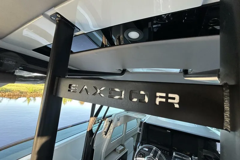 Slide: The Image of Interior view of 2022 Saxdor 320 GTO boat, showcasing steering wheel and design details. - 14