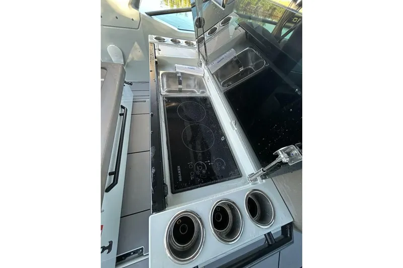Slide: The Image of Compact kitchen area on 2022 Saxdor 320 GTO boat with stove and sink. - 15