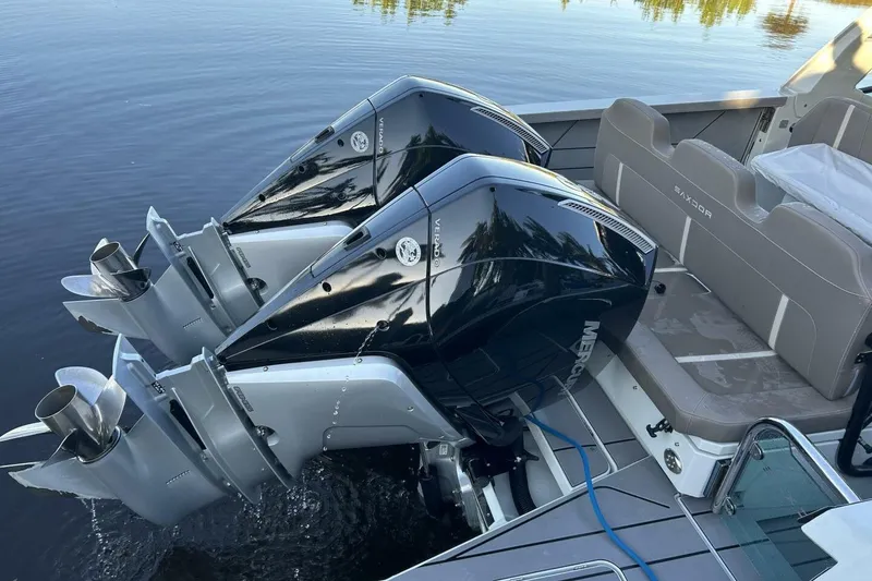Slide: The Image of 2022 Saxdor 320 GTO with dual Mercury outboard engines on calm water. - 16