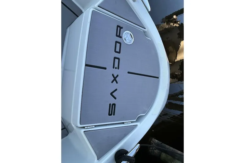 Slide: The Image of 2022 Saxdor 320 GTO boat deck with logo, docked on calm water. - 17