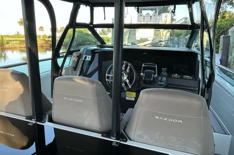 Slide: The Image of 2022 Saxdor 320 GTO boat interior with steering wheel and branded seats. - 7