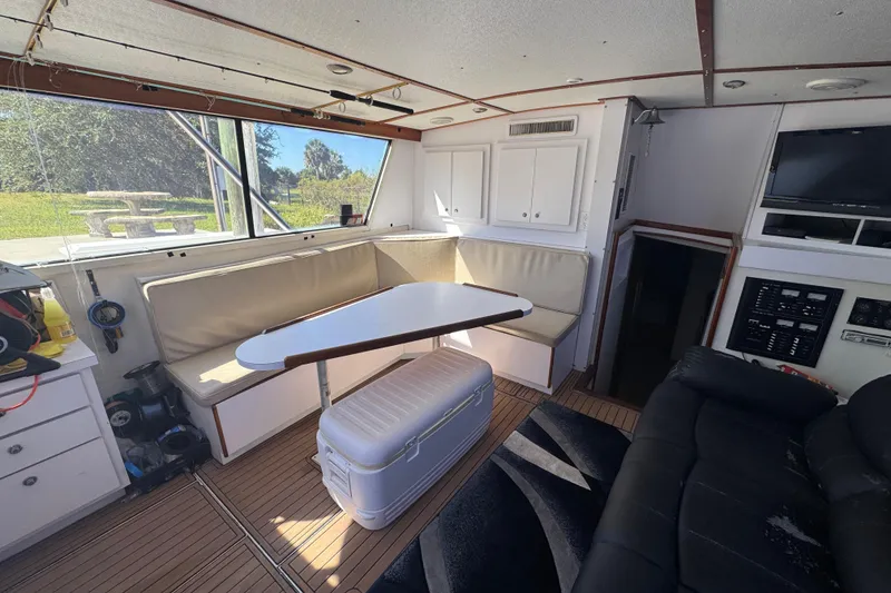 Slide: The Image of Interior of a 1965 Hatteras 41 Convertible yacht with seating and table. - 11