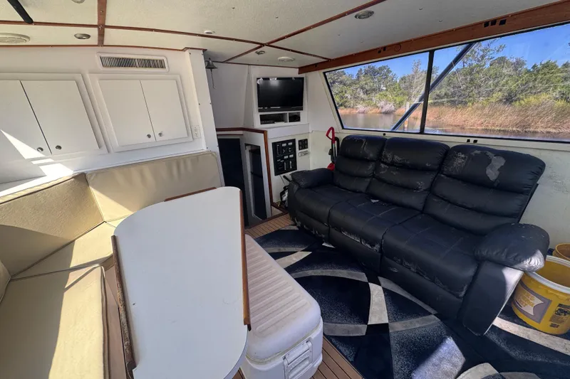 Slide: The Image of Interior of 1965 Hatteras 41 Convertible yacht with seating and windows. - 12