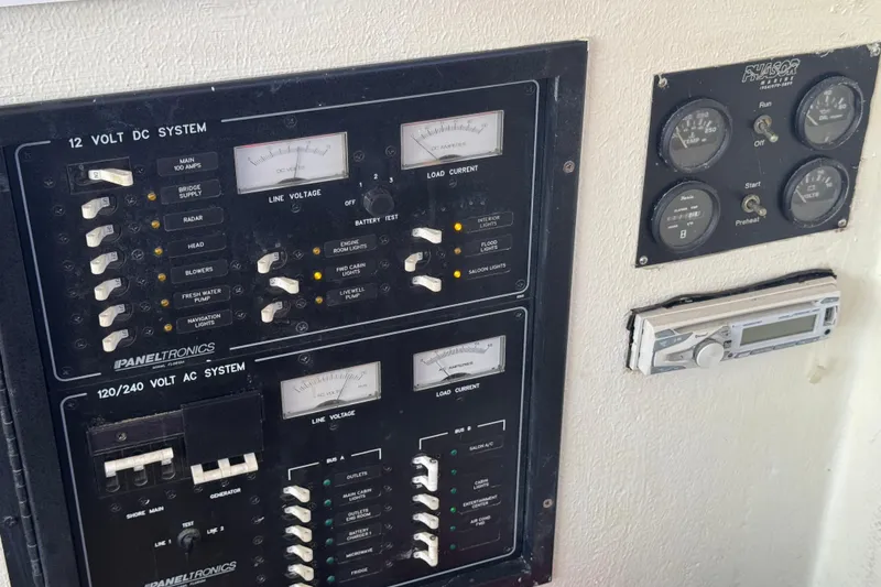 Slide: The Image of Electrical control panel on a 1965 Hatteras 41 Convertible boat, featuring gauges and switches. - 13