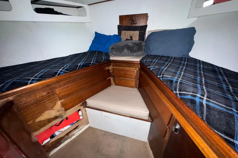 Slide: The Image of Interior cabin of a 1965 Hatteras 41 Convertible boat with twin beds and wooden storage. - 18