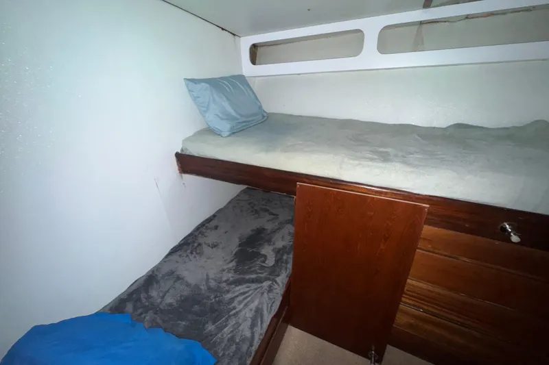Slide: The Image of Interior cabin of 1965 Hatteras 41 Convertible with bunk beds and wooden storage. - 19