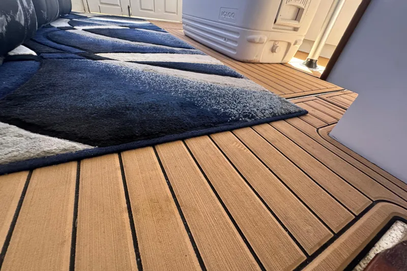 Slide: The Image of Teak deck with modern rug on 1965 Hatteras 41 Convertible boat interior. - 20